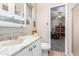 Well-lit bathroom featuring a vanity with storage and a view into the adjacent room at 5526 E Cicero St, Mesa, AZ 85205