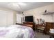 Cozy bedroom with a large TV and a decorative vanity at 5526 E Cicero St, Mesa, AZ 85205