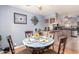 Quaint dining room with a decorative ceiling fan, a round table, and an adjacent kitchen at 5526 E Cicero St, Mesa, AZ 85205