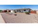 Attractive single-story home featuring low maintenance rock landscaping and colorful flower beds at 5526 E Cicero St, Mesa, AZ 85205