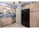 Bright kitchen featuring stainless steel dishwasher and a black refrigerator at 5526 E Cicero St, Mesa, AZ 85205