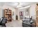 Comfortable living room featuring a recliner and built-in bookshelves at 5526 E Cicero St, Mesa, AZ 85205