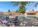 Inviting community pool area with patio seating and a covered poolside structure at 5848 W Gelding Dr, Glendale, AZ 85306