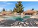 Exterior of a large community pool area with clear blue water and lounge seating at 5848 W Gelding Dr, Glendale, AZ 85306