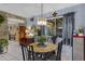 Bright dining room features a modern chandelier and views of the back patio at 5848 W Gelding Dr, Glendale, AZ 85306