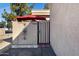 Gated entrance featuring address numbers and decorative ironwork on a white brick wall at 5848 W Gelding Dr, Glendale, AZ 85306