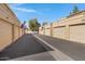 A row of tan garages with American flags in a well-maintained community at 5848 W Gelding Dr, Glendale, AZ 85306