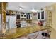 Well-lit kitchen featuring a breakfast bar, lots of counter space, and custom cabinets at 5848 W Gelding Dr, Glendale, AZ 85306