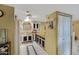 Traditional kitchen featuring white appliances, wooden cabinets, and white tile floors at 5848 W Gelding Dr, Glendale, AZ 85306