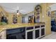 Traditional kitchen featuring yellow walls, wooden cabinets, and a breakfast bar at 5848 W Gelding Dr, Glendale, AZ 85306