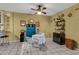 Cozy living room with tile flooring, a ceiling fan, and a small dining area at 5848 W Gelding Dr, Glendale, AZ 85306