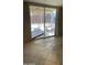 Living room featuring tiled floors and access to the patio at 6617 W Peck Dr, Glendale, AZ 85301