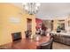 Elegant dining room with a chandelier, wood table, and views into the living area at 7520 S Jentilly Ln, Tempe, AZ 85283