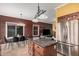 Kitchen island with granite counters, stainless fridge, and dining table at 7520 S Jentilly Ln, Tempe, AZ 85283