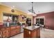 Well-lit kitchen with granite counters, wood cabinets, and stainless dishwasher at 7520 S Jentilly Ln, Tempe, AZ 85283