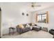 Cozy living room with a ceiling fan, sectional sofa, and a window with natural light at 7520 S Jentilly Ln, Tempe, AZ 85283