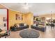 Bright living room with tan tiled floor, modern sofas, and ceiling fan at 7520 S Jentilly Ln, Tempe, AZ 85283