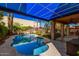 Backyard with a free form swimming pool under a blue awning adjacent to the covered patio and lush landscaping at 7520 S Jentilly Ln, Tempe, AZ 85283