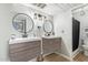 This bathroom features two modern vanities, each with stylish round mirrors and elegant fixtures at 8055 E Thomas Rd # E106, Scottsdale, AZ 85251