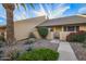 Charming home featuring desert landscaping, a palm tree, and vibrant red flowering shrubs at 8055 E Thomas Rd # E106, Scottsdale, AZ 85251