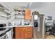 Galley kitchen showcasing white subway tile backsplash, stainless steel refrigerator and ample cabinet space at 8055 E Thomas Rd # E106, Scottsdale, AZ 85251