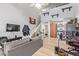 Cozy living area with hardwood floors, exposed shelving, and a gray sofa at 8055 E Thomas Rd # E106, Scottsdale, AZ 85251