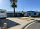 A single-story home with blue trim sits on a lot with a large palm tree and a long driveway at 8124 N 45Th Ave, Glendale, AZ 85302