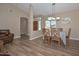 Inviting dining area featuring wood floors and a charming table setting at 8444 W Rockwood Dr, Peoria, AZ 85382