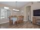 A dining room features matching table and chairs with laminate wood flooring at 8444 W Rockwood Dr, Peoria, AZ 85382