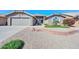 Well-manicured front yard featuring a brick border, palm tree and desert landscaping at 8444 W Rockwood Dr, Peoria, AZ 85382