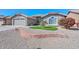 Beautifully landscaped front yard with desert rock and a colorful shrub at 8444 W Rockwood Dr, Peoria, AZ 85382