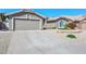 Exterior view of the home featuring desert landscaping and a two-car garage at 8444 W Rockwood Dr, Peoria, AZ 85382