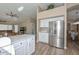 Spacious kitchen with stainless steel refrigerator and open flow to the living and dining areas at 8444 W Rockwood Dr, Peoria, AZ 85382