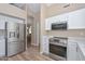 Kitchen featuring stainless steel appliances, white cabinets, and marble countertops at 8444 W Rockwood Dr, Peoria, AZ 85382