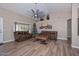 Spacious living room featuring wood flooring, high ceilings, and comfortable leather seating at 8444 W Rockwood Dr, Peoria, AZ 85382