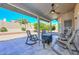 A serene covered patio provides a relaxing outdoor living space with seating at 8444 W Rockwood Dr, Peoria, AZ 85382