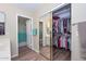 Well-organized walk-in closet with mirror doors, ample storage, and easy access to the bathroom at 8444 W Rockwood Dr, Peoria, AZ 85382