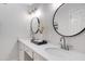 Bathroom featuring double sinks and round mirrors at 8556 E Pecos Ln, Scottsdale, AZ 85250