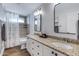 Bathroom with double sinks, granite countertops, and shower at 8556 E Pecos Ln, Scottsdale, AZ 85250