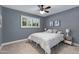 Bedroom with a ceiling fan and plantation shutters at 8556 E Pecos Ln, Scottsdale, AZ 85250