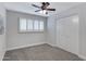 Bedroom features a ceiling fan and plantation shutters at 8556 E Pecos Ln, Scottsdale, AZ 85250