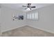 Neutral bedroom with a ceiling fan and plantation shutters at 8556 E Pecos Ln, Scottsdale, AZ 85250