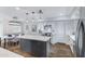 Bright kitchen with white cabinets, quartz countertops, stainless steel appliances, and wood-look tile flooring at 8556 E Pecos Ln, Scottsdale, AZ 85250