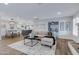 Open-concept living room flowing into the kitchen and dining areas with hardwood flooring and stylish decor at 8556 E Pecos Ln, Scottsdale, AZ 85250