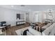 Bright living room leading into the kitchen and dining area, with stylish decor and wood-look flooring at 8556 E Pecos Ln, Scottsdale, AZ 85250