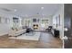 Bright living room with a fireplace, recessed lighting, modern decor, and wood-look tile floors at 8556 E Pecos Ln, Scottsdale, AZ 85250