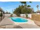 Inviting backyard pool with a stamped concrete patio, offering a relaxing oasis surrounded by mature landscaping at 8556 E Pecos Ln, Scottsdale, AZ 85250