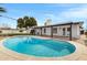 Backyard pool, perfect for summer days, surrounded by a well maintained patio and lush landscaping at 8556 E Pecos Ln, Scottsdale, AZ 85250