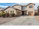 Inviting two-story home with a well-maintained front yard and a spacious two-car garage at 868 W Desert Glen Dr, San Tan Valley, AZ 85143