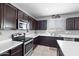 Cozy kitchen featuring a stainless steel microwave, oven, and a 'cafe' sign at 868 W Desert Glen Dr, San Tan Valley, AZ 85143